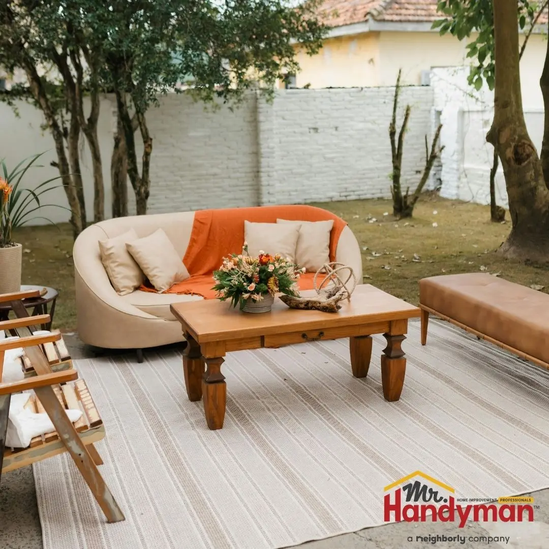 handyman installing deck lighting for summer outdoor entertaining