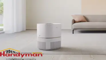 handyman inspecting backflow prevention device in Charleston SC home