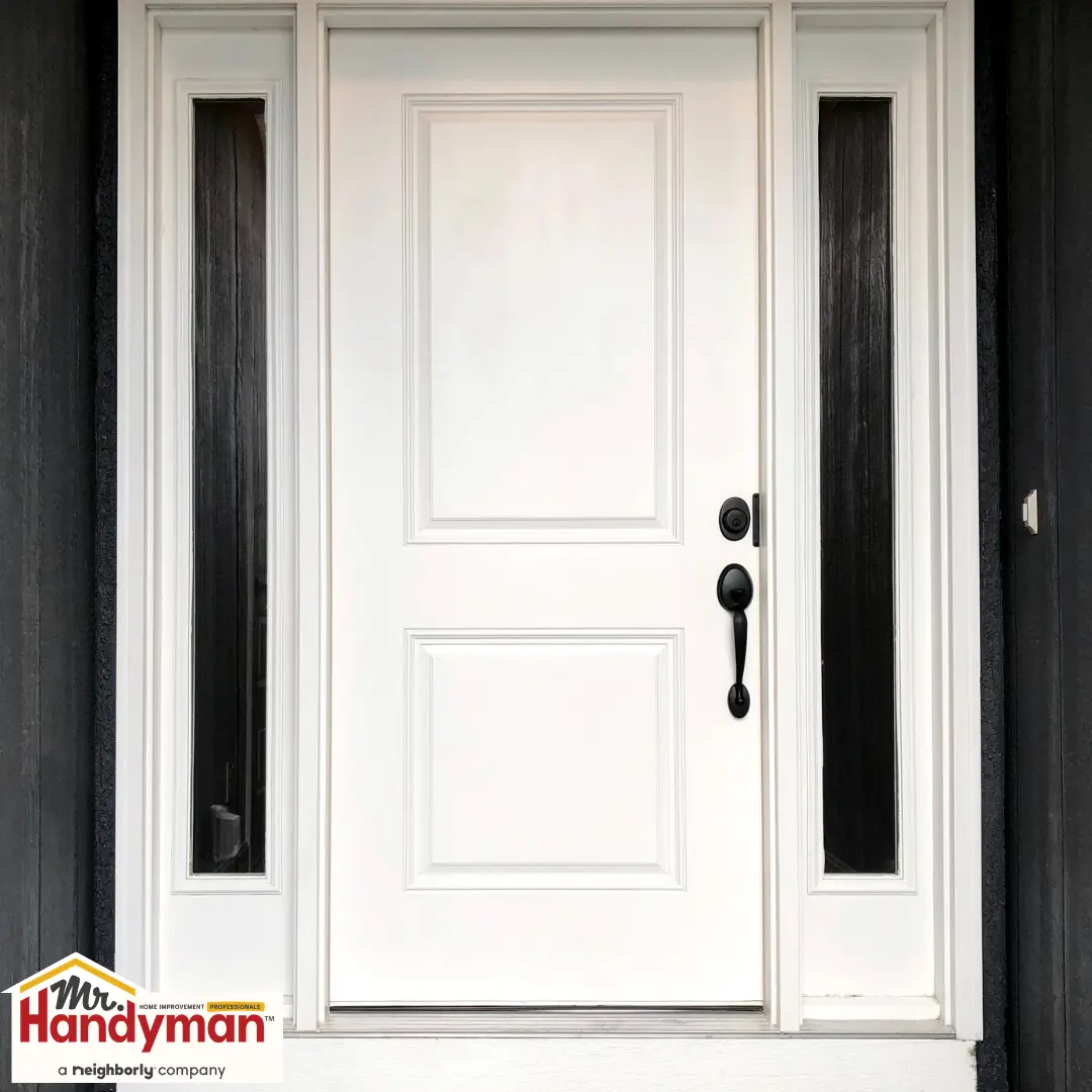 A white front door with black hardware.