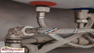 Close-up of flexible braided water supply hoses.