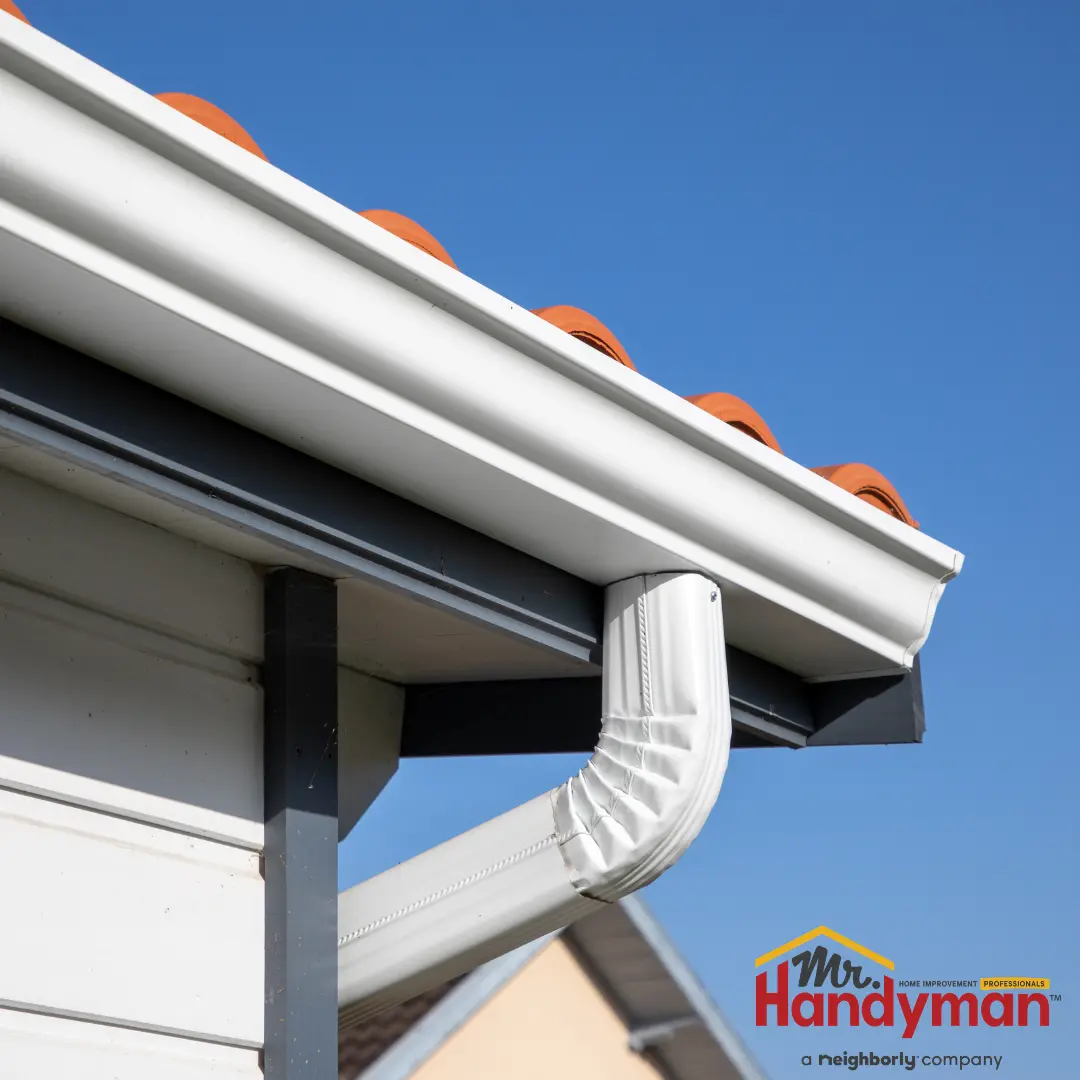 Image of a roof edge with a white gutter system.