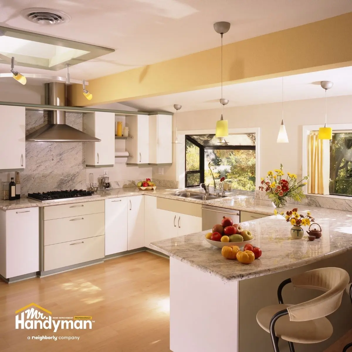 modern kitchen with white cabinets and marble countertops.