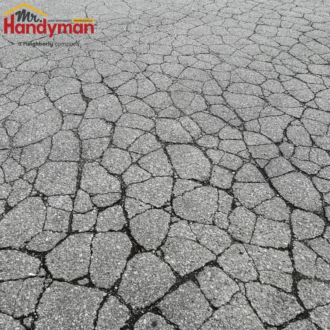 Handyman inspecting a commercial parking lot for safety hazards in Martinsburg West Virginia.