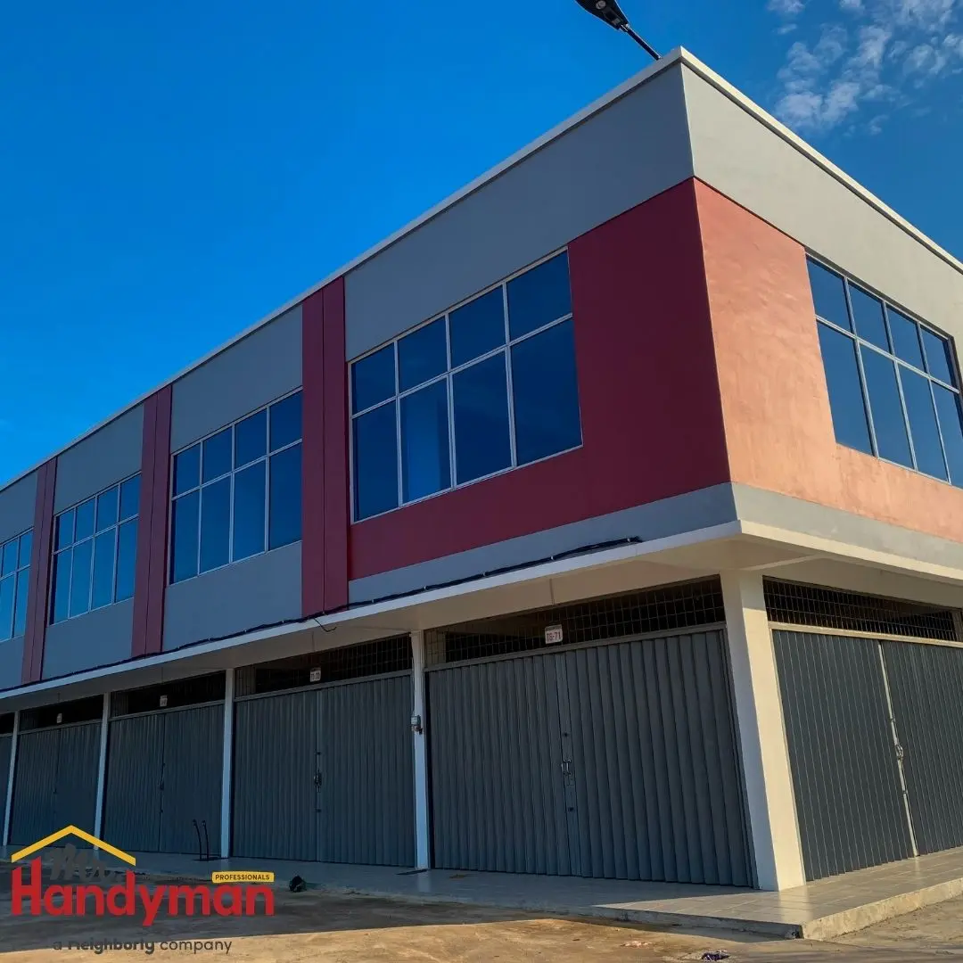 A large, multi-story building with a red and grey exterior.
