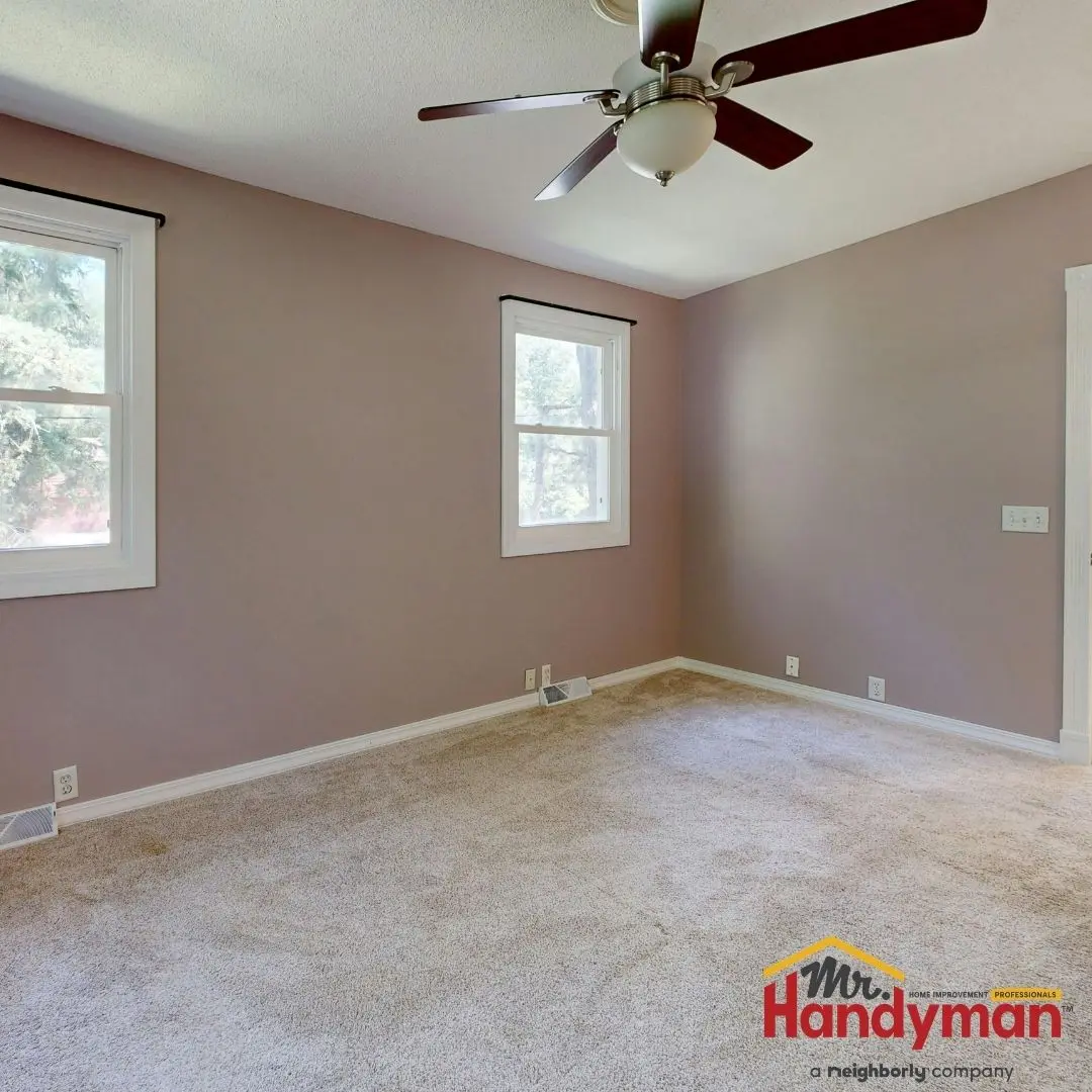 Handyman installing crown molding in a living room in Martinsburg West Virginia