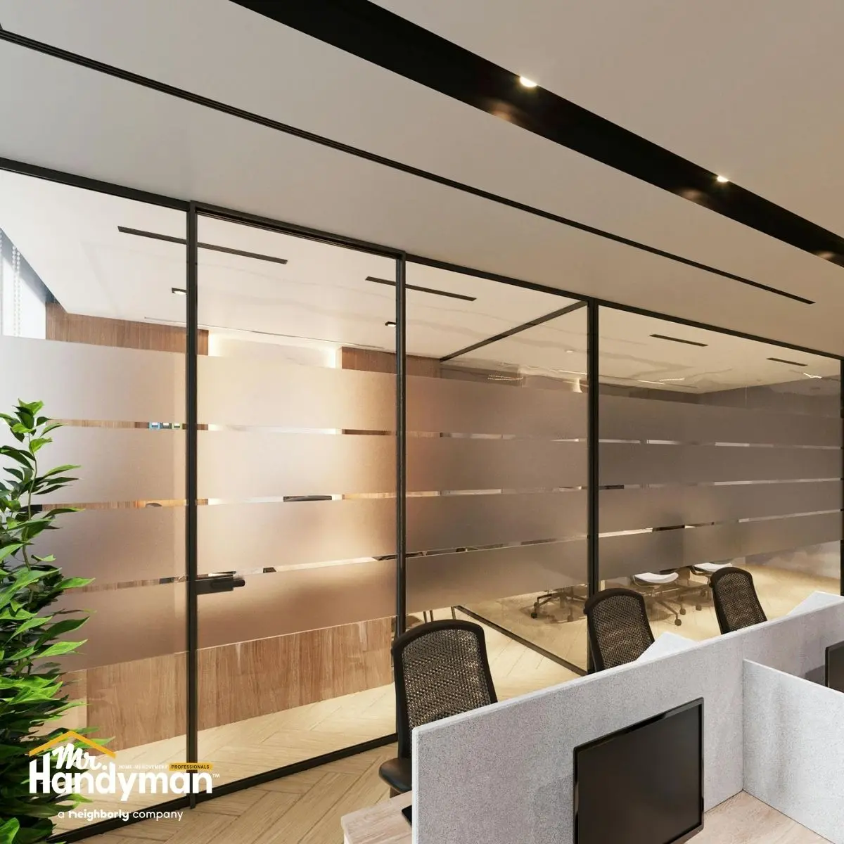Modern office interior with frosted glass partitions and sleek furniture.