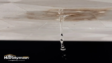Mr. Handyman technician inspecting water damage on ceiling in Wichita home