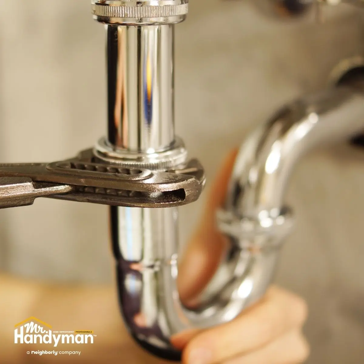 Mr. Handyman technician installing a new kitchen faucet and plumbing fixtures in a Nashville home