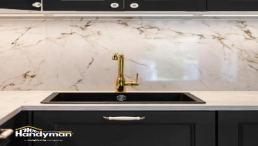 Mr. Handyman technician installing kitchen faucet in Wichita home
