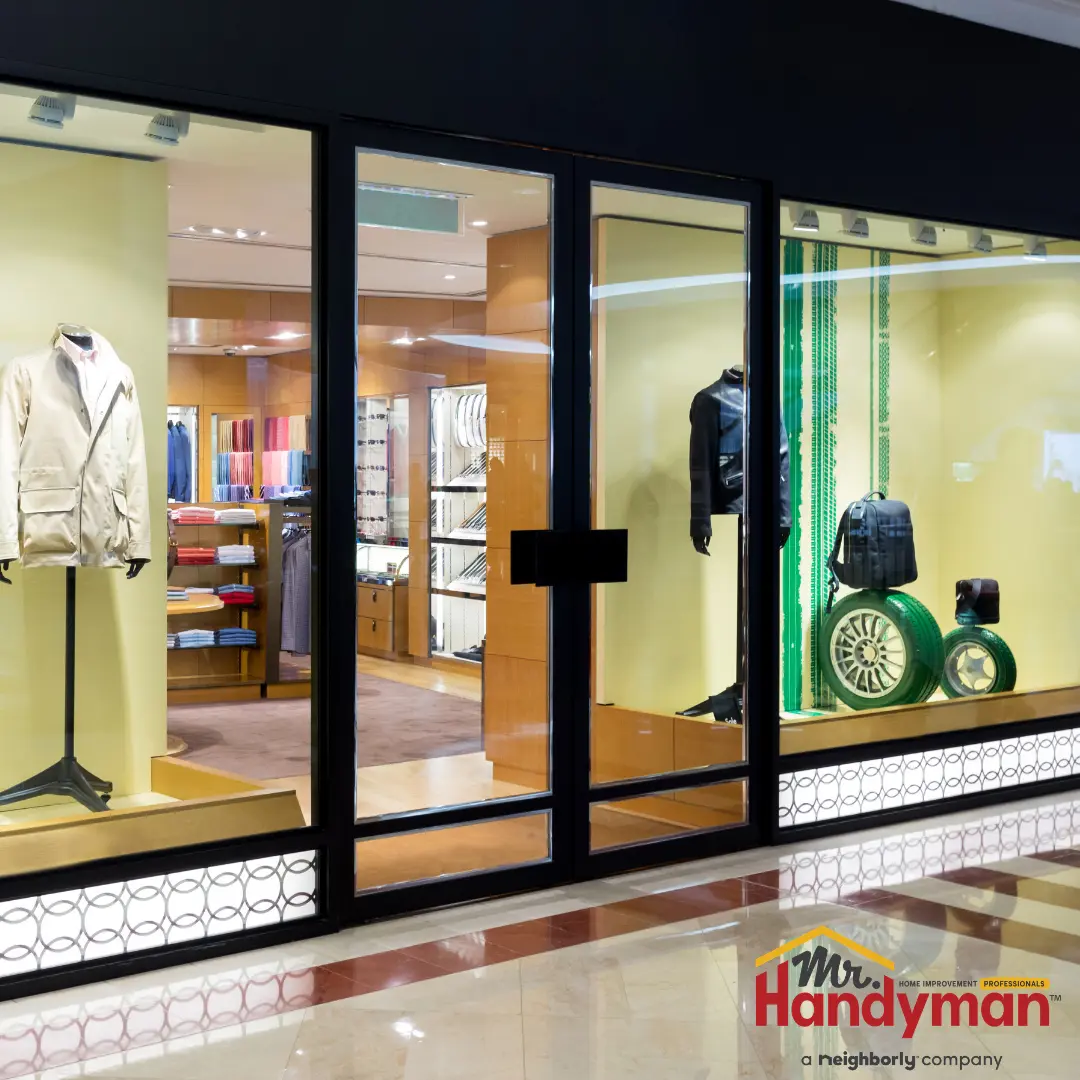 Mr. Handyman technician repairing entry flooring and door hardware at a high-traffic