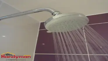 A chrome shower head mounted on a wall.