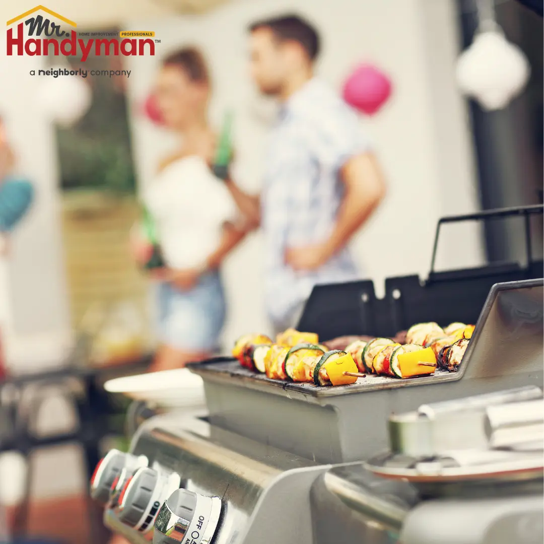 A group of people gathered around a grill.