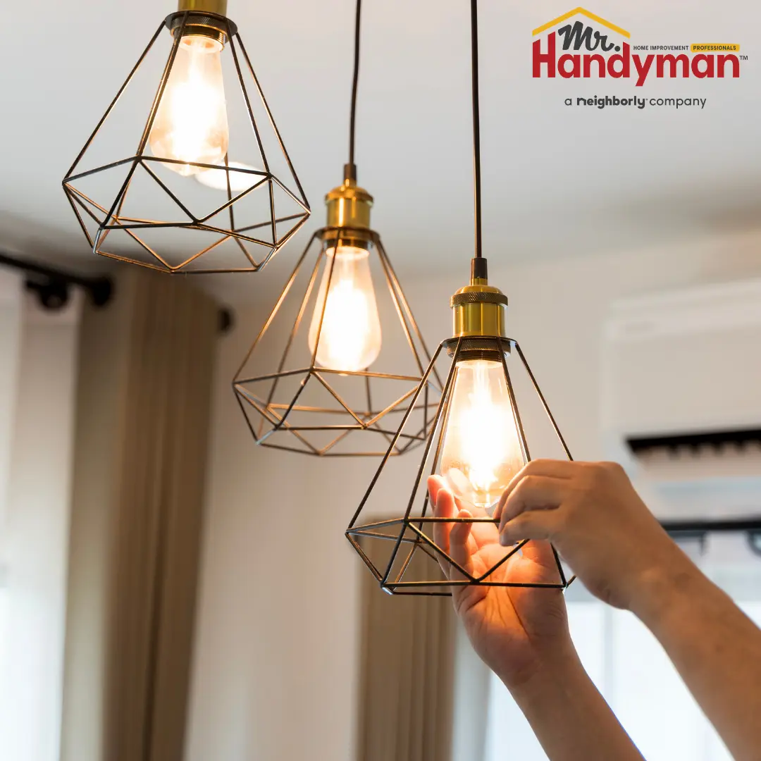 Mr. Handyman technician installing coordinated cabinet hardware and caulking trim joints in a Greensburg, Pennsylvania home remodel