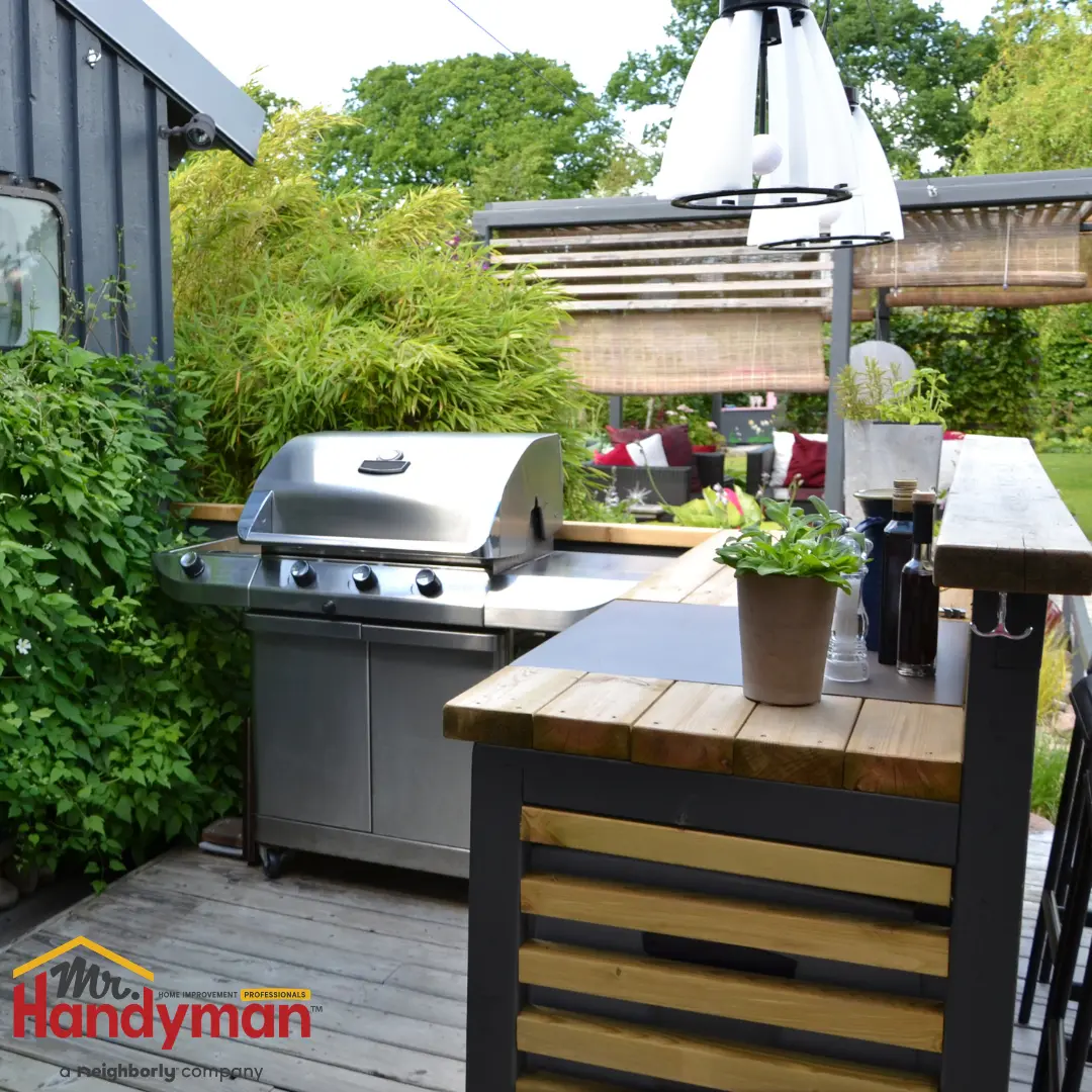 Mr. Handyman technician installing outdoor deck lighting and a ceiling fan.