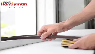 Mr. Handyman technician repairing a dripping faucet and exterior caulking on a South Bend, Indiana home to prevent larger damage