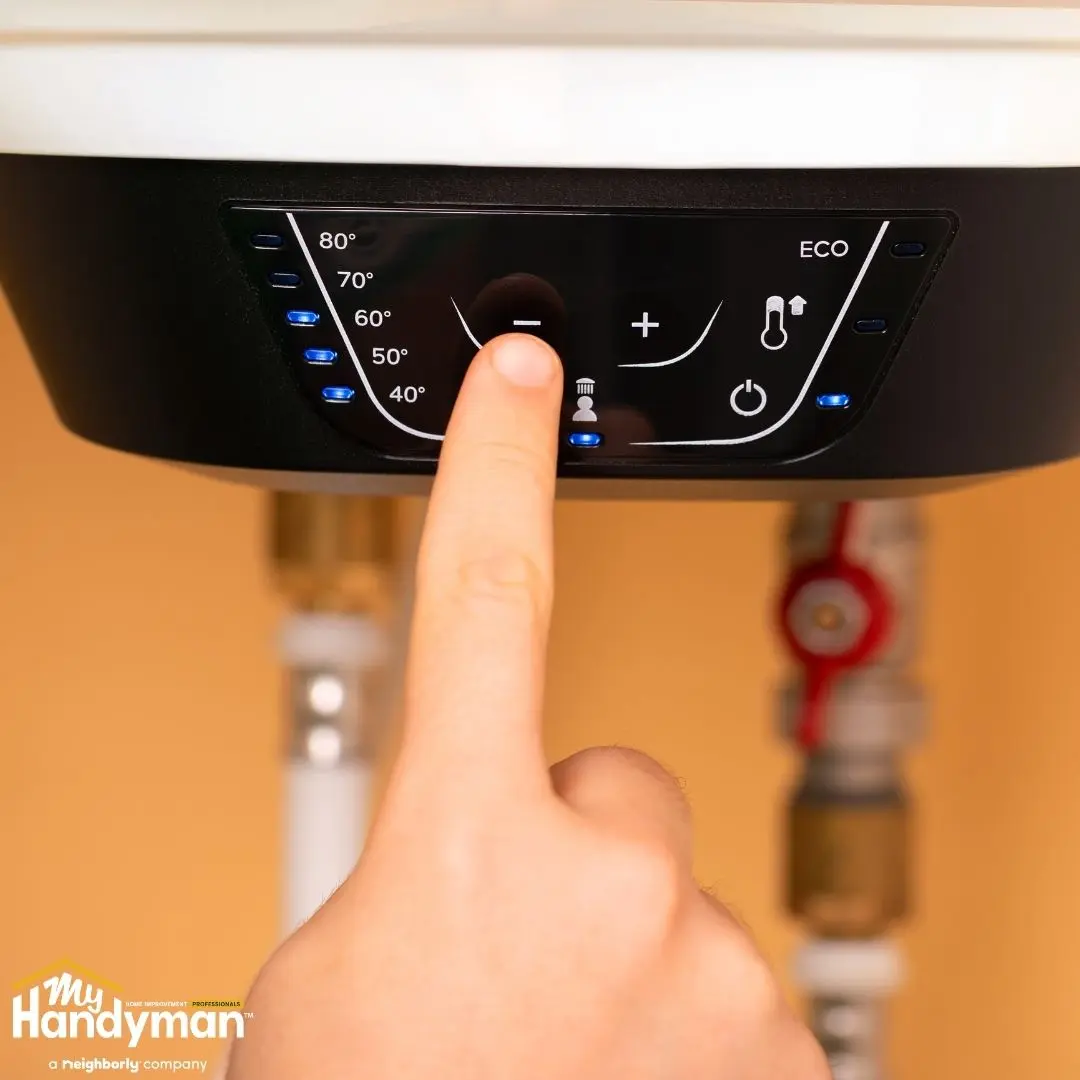 A hand adjusts the temperature.