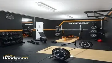 Mr. Handyman technician performing paint touch-up repairs on a fitness facility wall in Nashville
