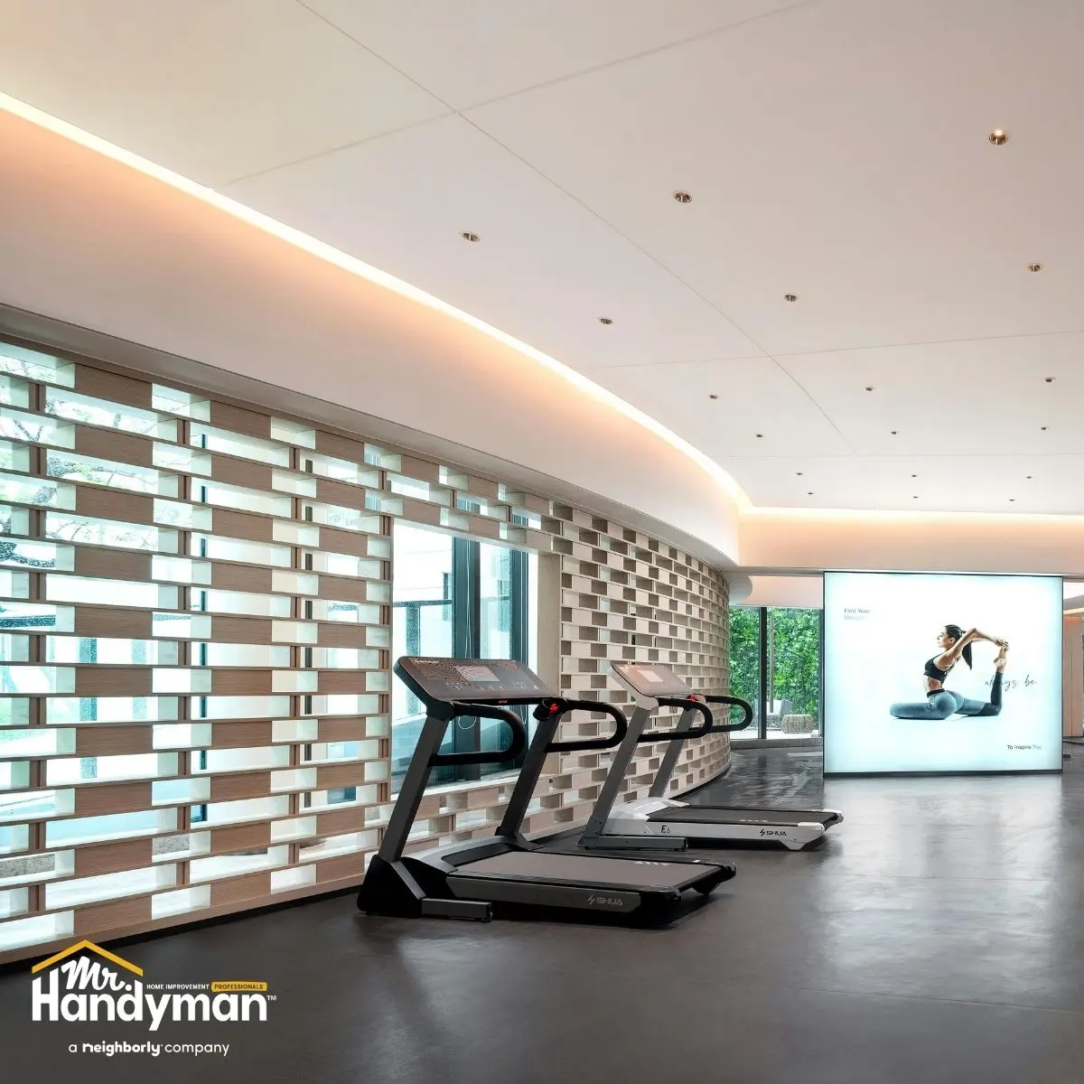 Mr. Handyman technician performing paint touch-up repairs on a fitness facility wall in Nashville