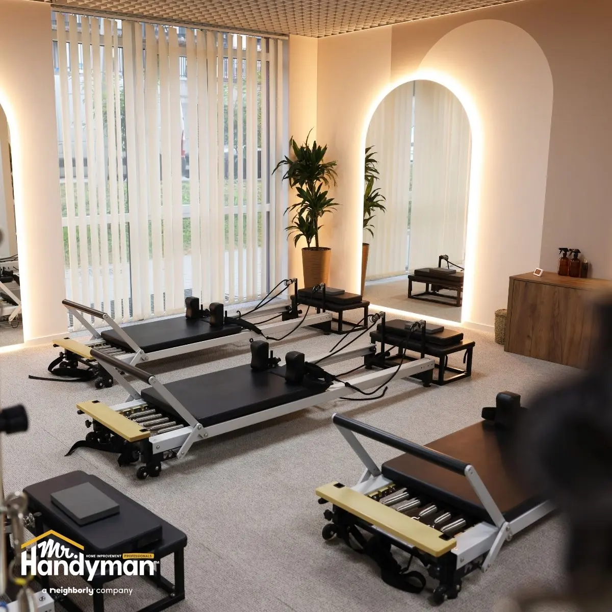 Bright Pilates studio with multiple reformer machines.