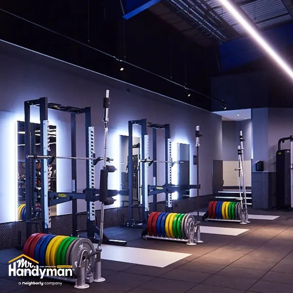 A modern gym interior featuring weightlifting racks.