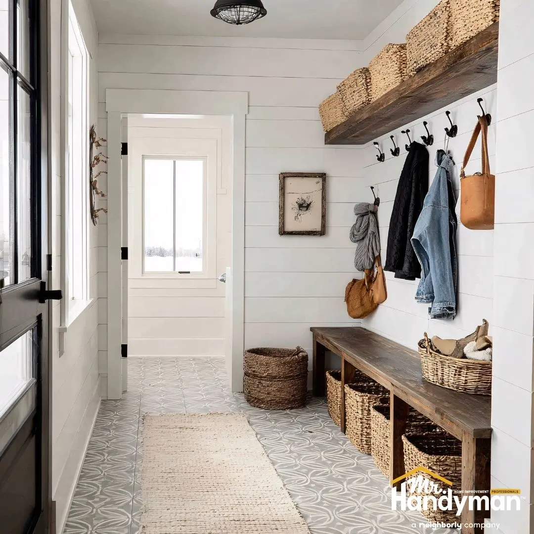 A stylish entryway featuring white shiplap walls.