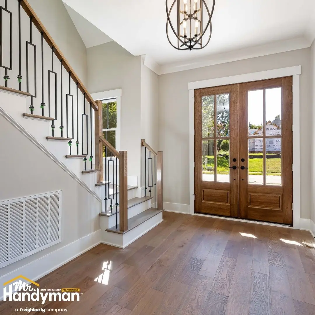 Bright foyer featuring a wooden staircase.