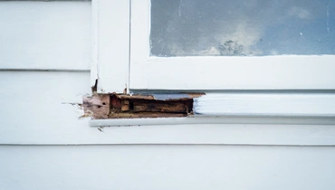 Damaged wood around window.