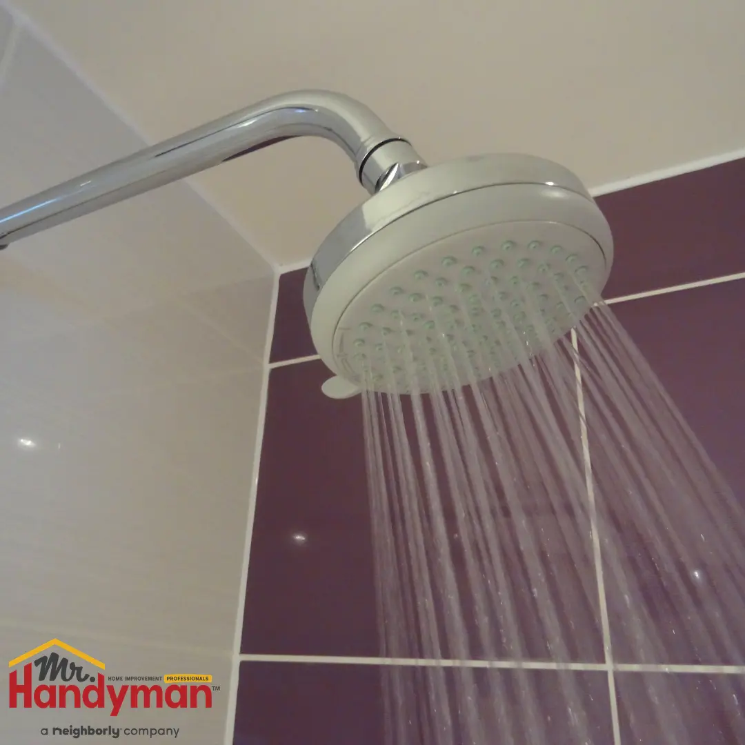 A chrome shower head mounted on a wall.