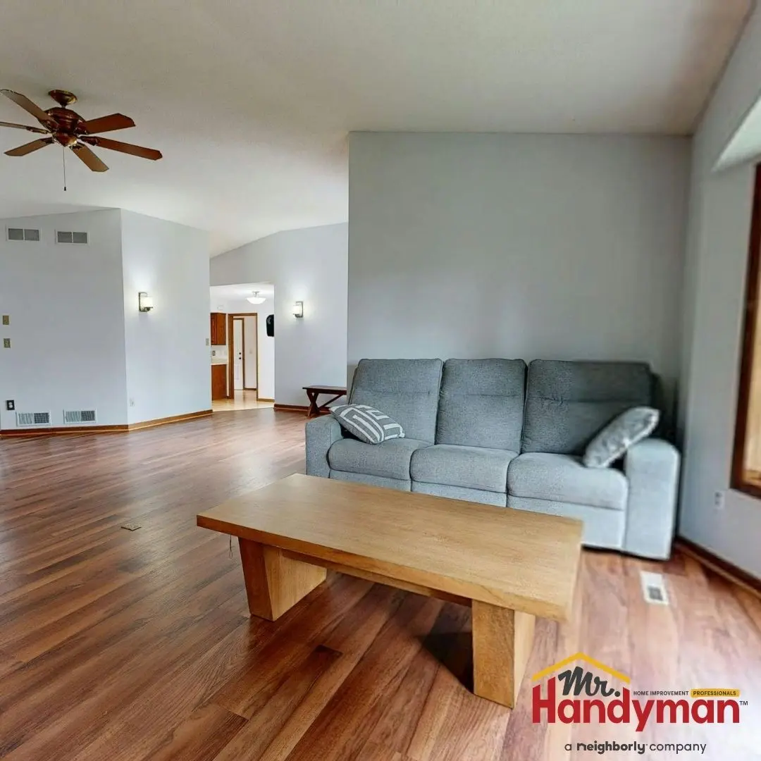 Handyman installing luxury vinyl plank flooring in a Rockwall, TX home.