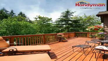 Handyman repairing a deck railing at a Rockwall, TX home.