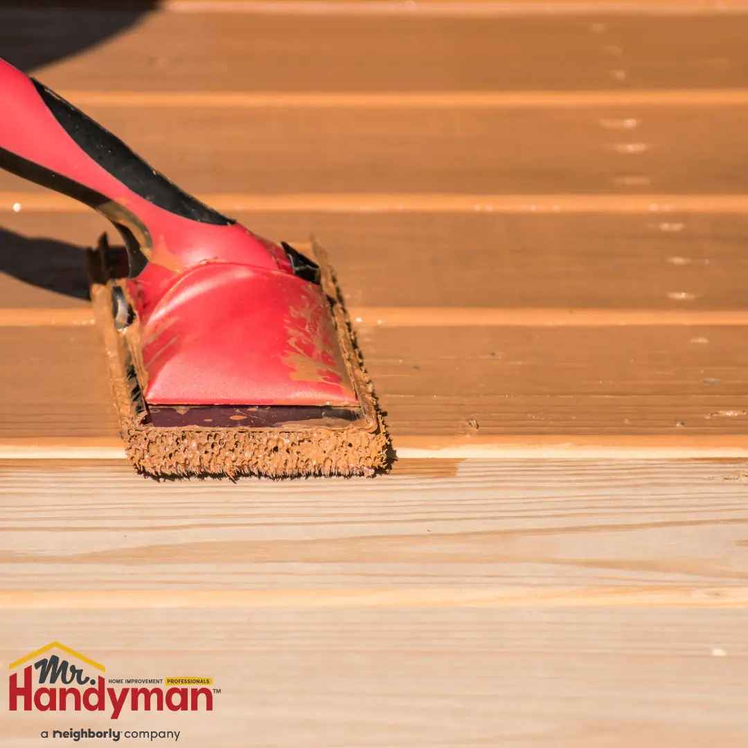 Handyman repairing a deck railing at a Rockwall, TX home