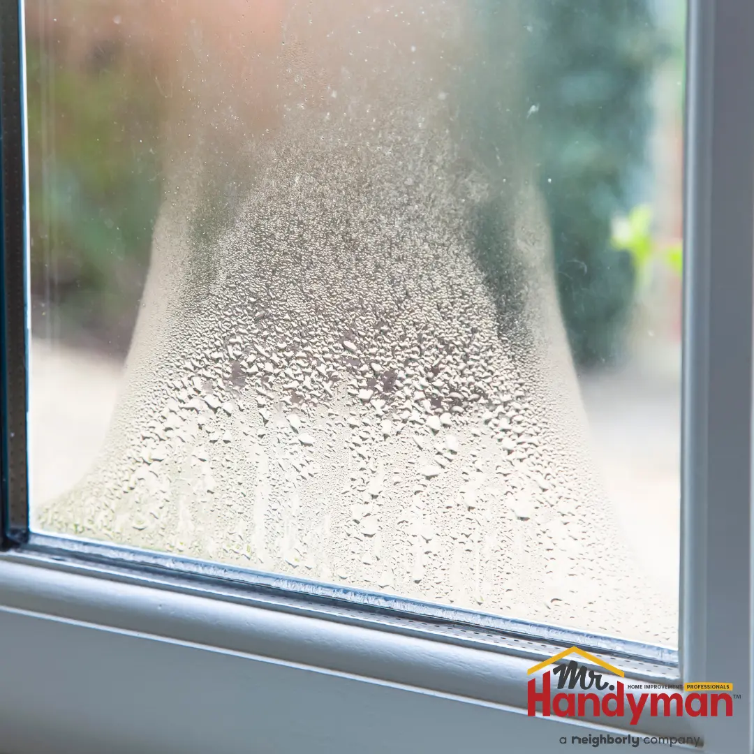Handyman installing a replacement window in a Mishawaka, IN home