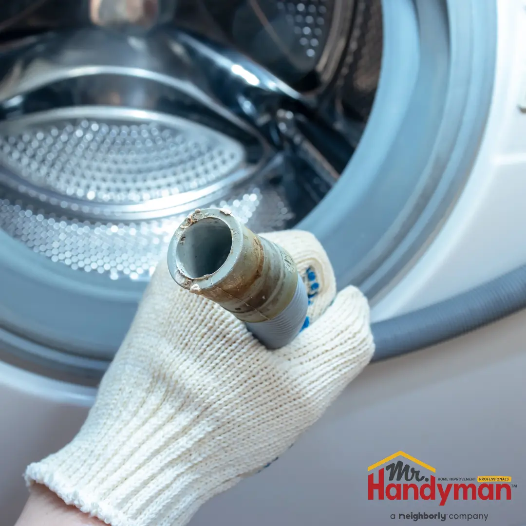 Handyman inspecting a water heater in a Charles Town, WV home.