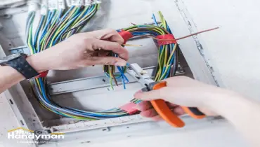 Mr. Handyman technician replacing and maintaining lighting fixtures inside a South Bend Northern Indiana fitness facility