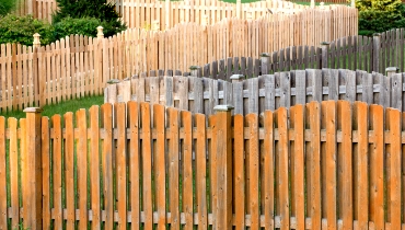 Several rows of different fences near each other, some of which have damage or wear that can be fixed with professional fence repair in Arlington, TX.