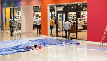 Mr. Handyman technician refreshing a commercial entry area in a Murfreesboro business during a small renovation.