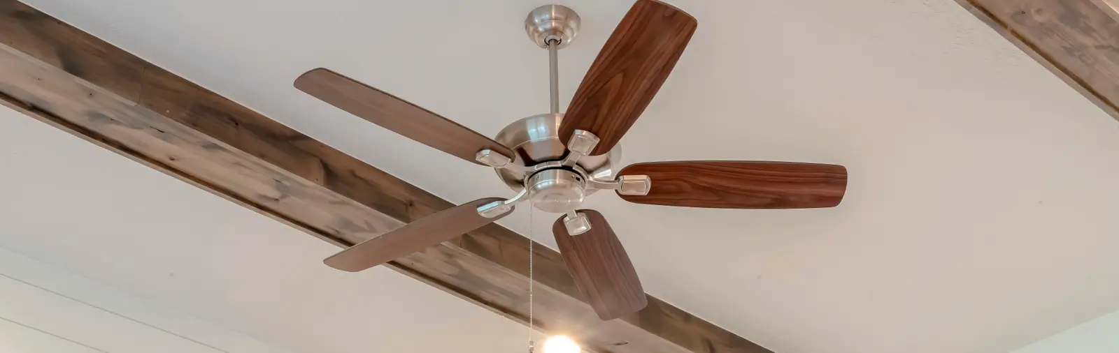 Close-up of a modern ceiling fan installed on a ceiling