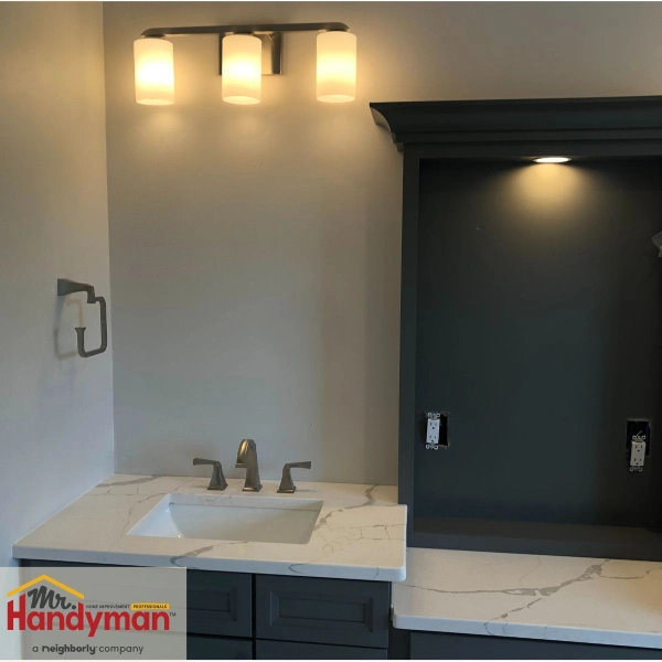 Bathroom vanity with modern triple light fixture installed by Mr. Handyman of Nashville, West, South and Central.
