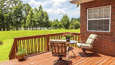 wooden deck overlooking green field wooden deck overlooking green field