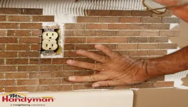 Mr. Handyman technician installing a new kitchen backsplash in a Greensburg, Pennsylvania home during summer remodeling season