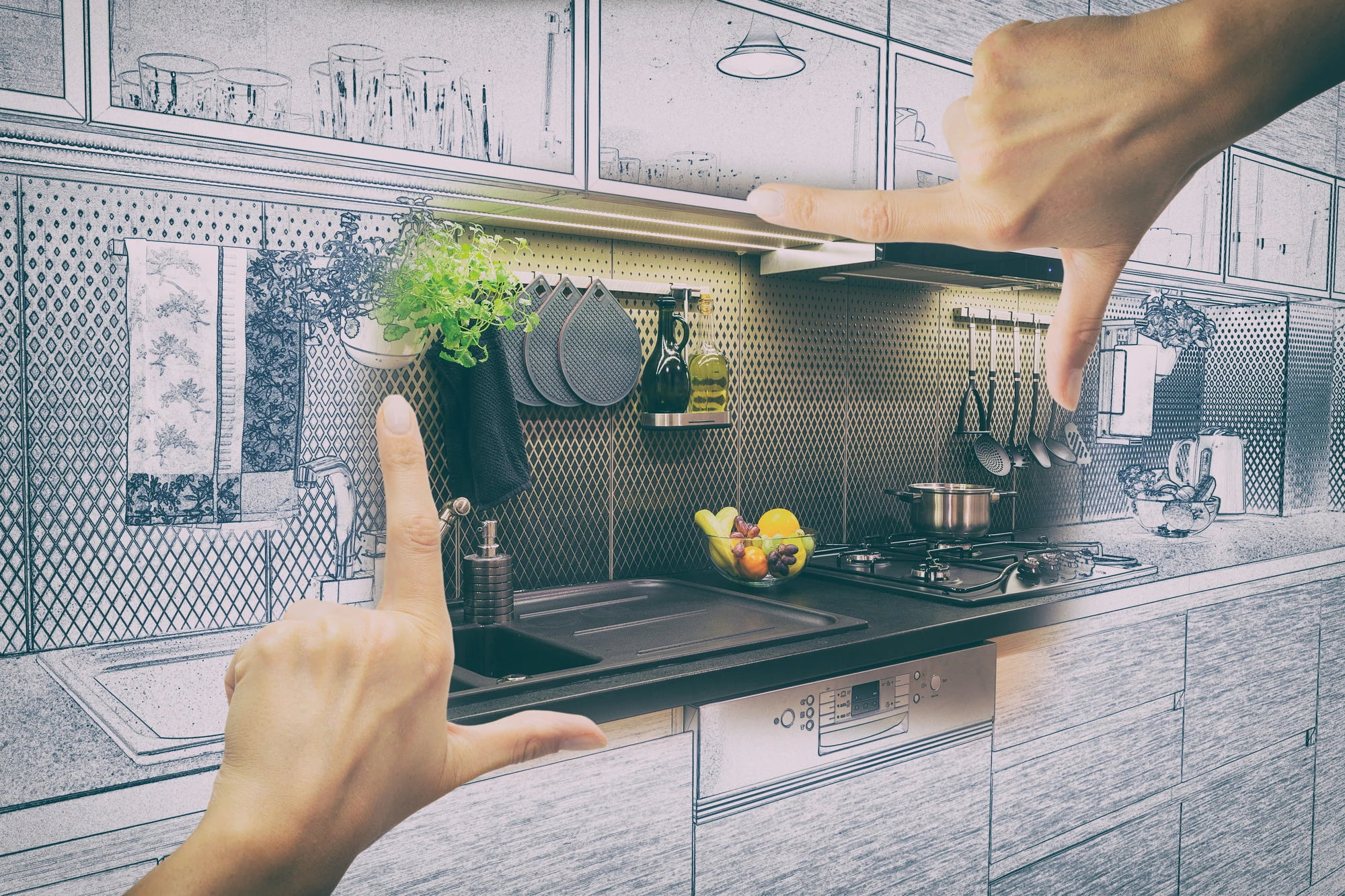 A hand framing a kitchen.