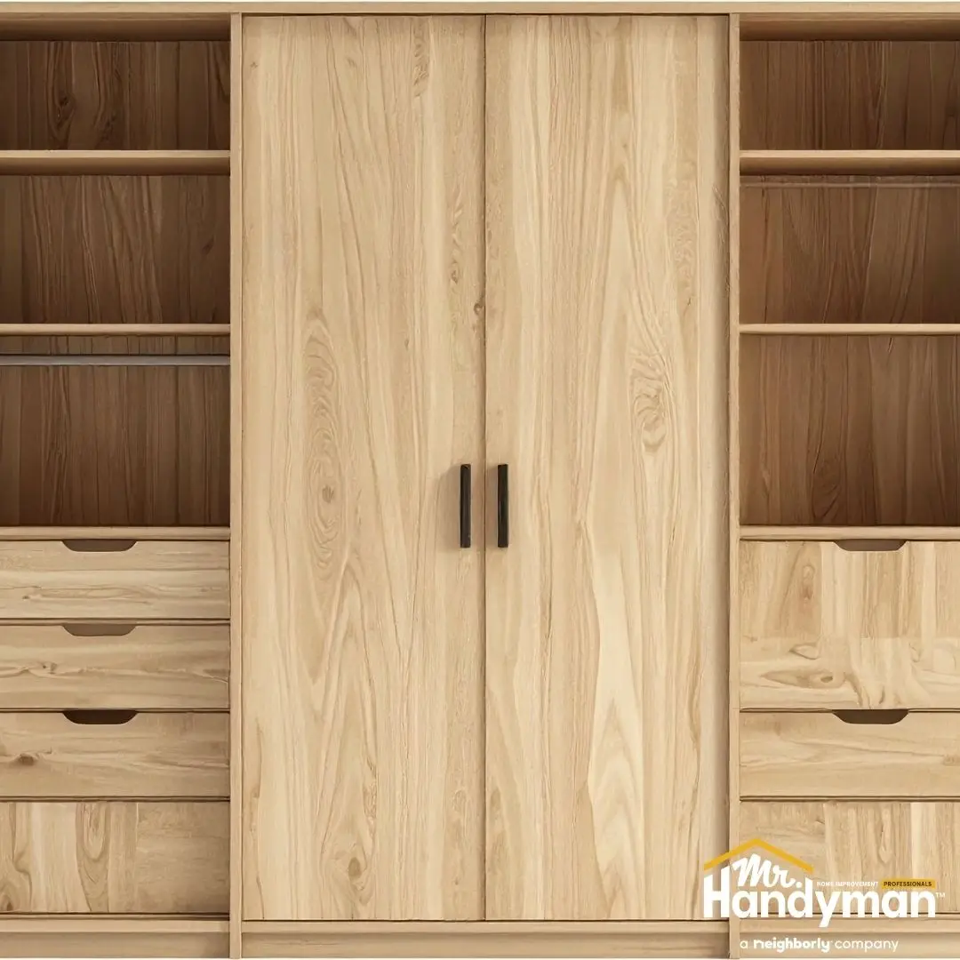 Built-in wooden storage cabinet with shelves, drawers, and double doors.