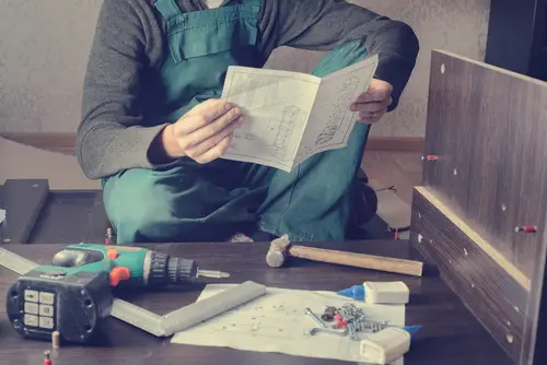 Homeowner struggling with confusing furniture assembly instructions