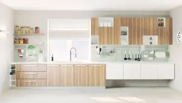 Kitchen with tan and white IKEA cabinets and fixtures.