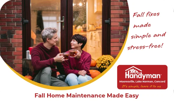 Man and woman sitting outside in front of glass doors.