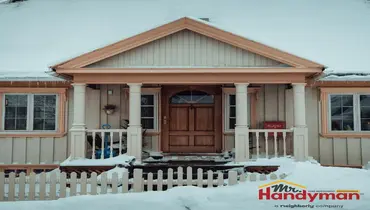 Mr. Handyman technician repairing exterior caulking and paint failure on a Dallas, Texas home after winter