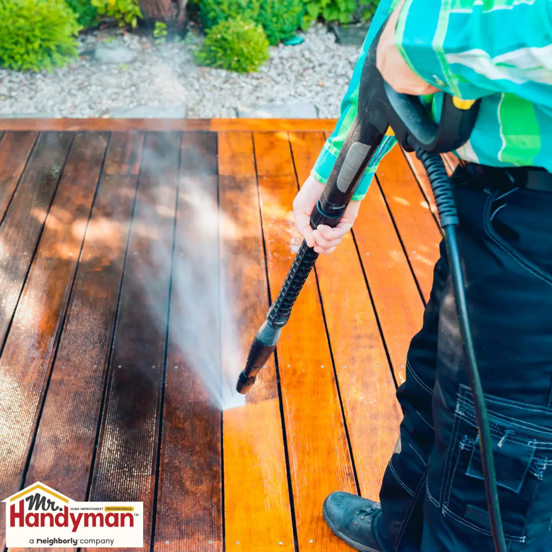 Handyman cleaning and staining a wood deck before the outdoor season in Murfreesboro Tennessee.