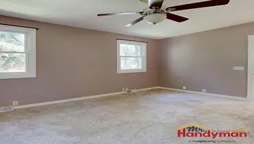 Handyman installing crown molding and trim in an Irving, TX home