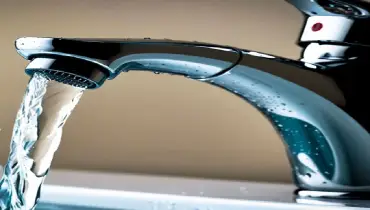 handyman inspecting winter plumbing and frozen pipe risk in Ann Arbor Michigan home