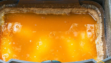 Overfilled restaurant grease trap requiring maintenance in South Bend Indiana commercial kitchen.